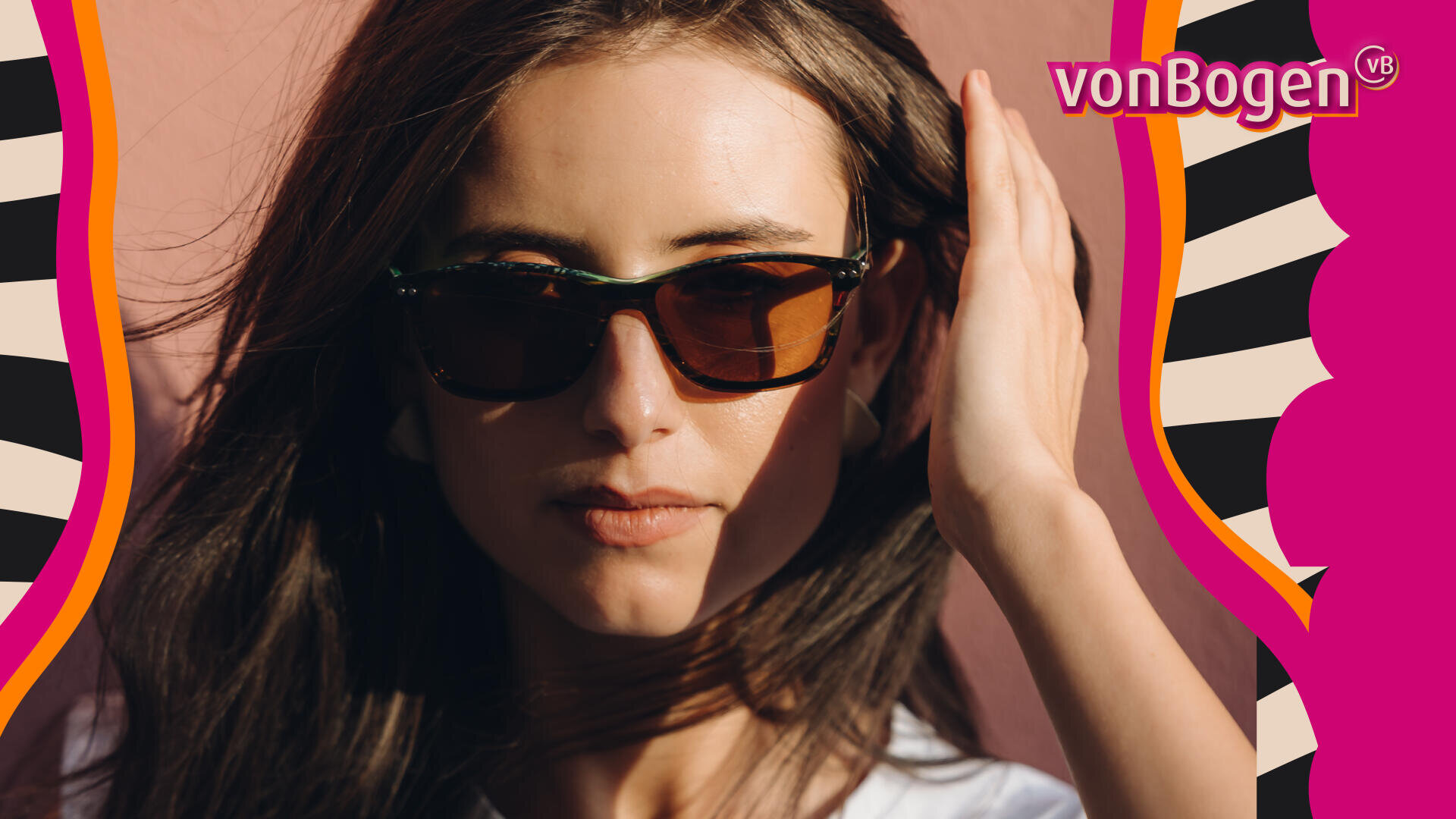 A woman with long brown hair wearing dark sunglasses looks at the camera, holding her hair back. The background is pink with wavy, colorful graphic borders and the vonBogen logo in the top right corner.
