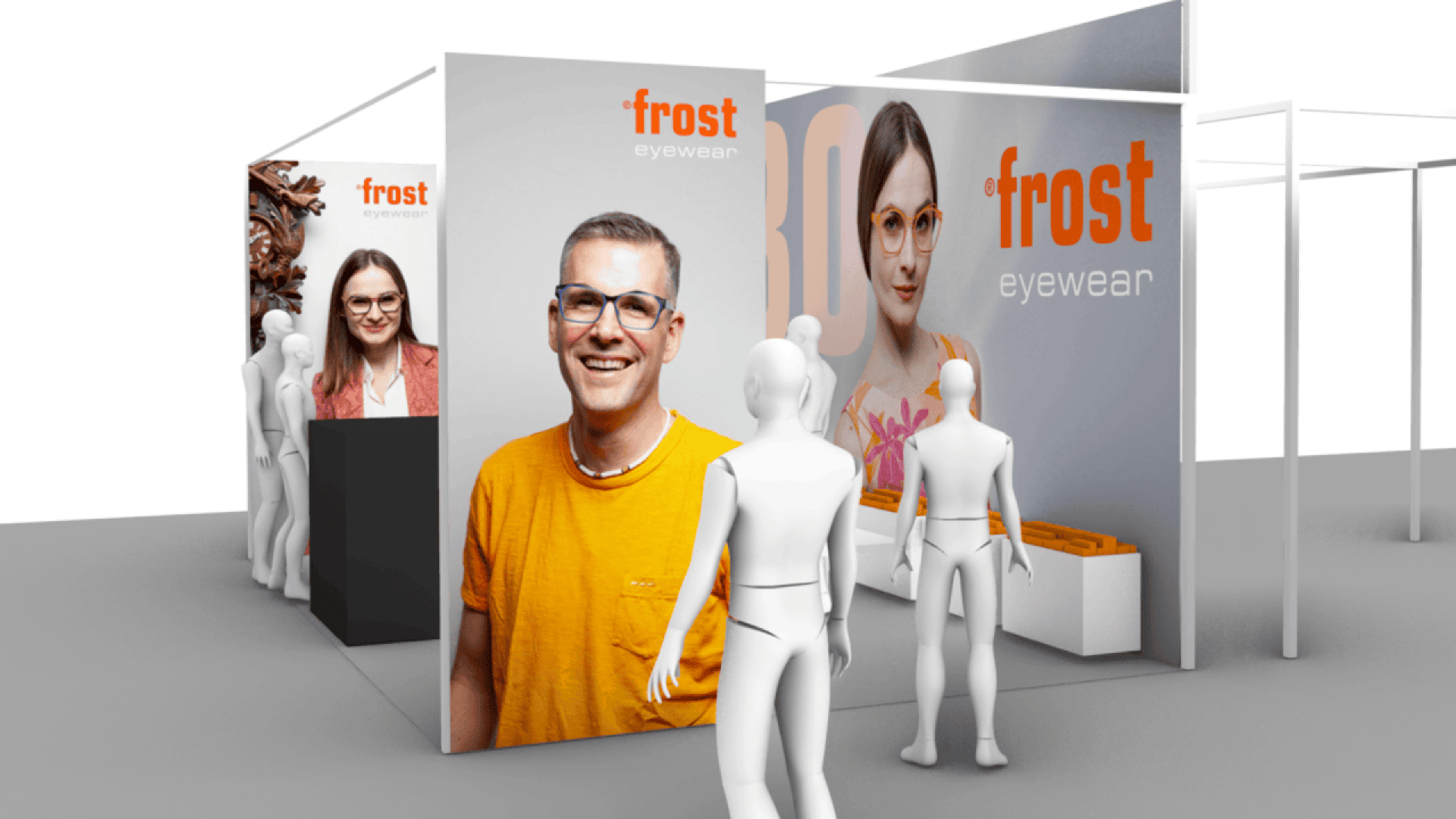 A trade show booth for Frost Eyewear with large posters of smiling people wearing glasses. White mannequin figures stand around the booth, which displays eyewear products on counters.