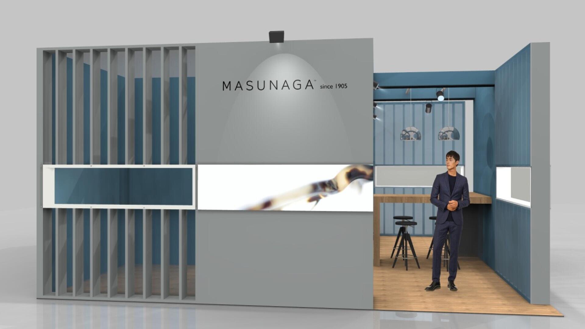 A modern exhibition booth with grey and blue walls features the MASUNAGA logo and since 1905. A man in a suit stands at the entrance; inside are stools, tables, and display shelves with eyeglasses.