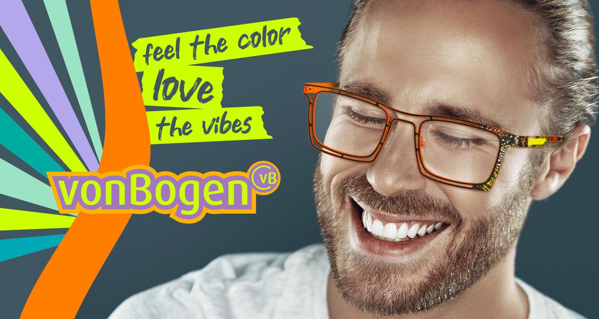 Ein lächelnder Mann mit langen Haaren und einem Bart trägt eine orangefarbene Brille. Bunte Strahlen und Text sagen, fühlen Sie die Farbe, lieben Sie die Vibes, vonBogen VB™ auf einem dunklen Hintergrund.