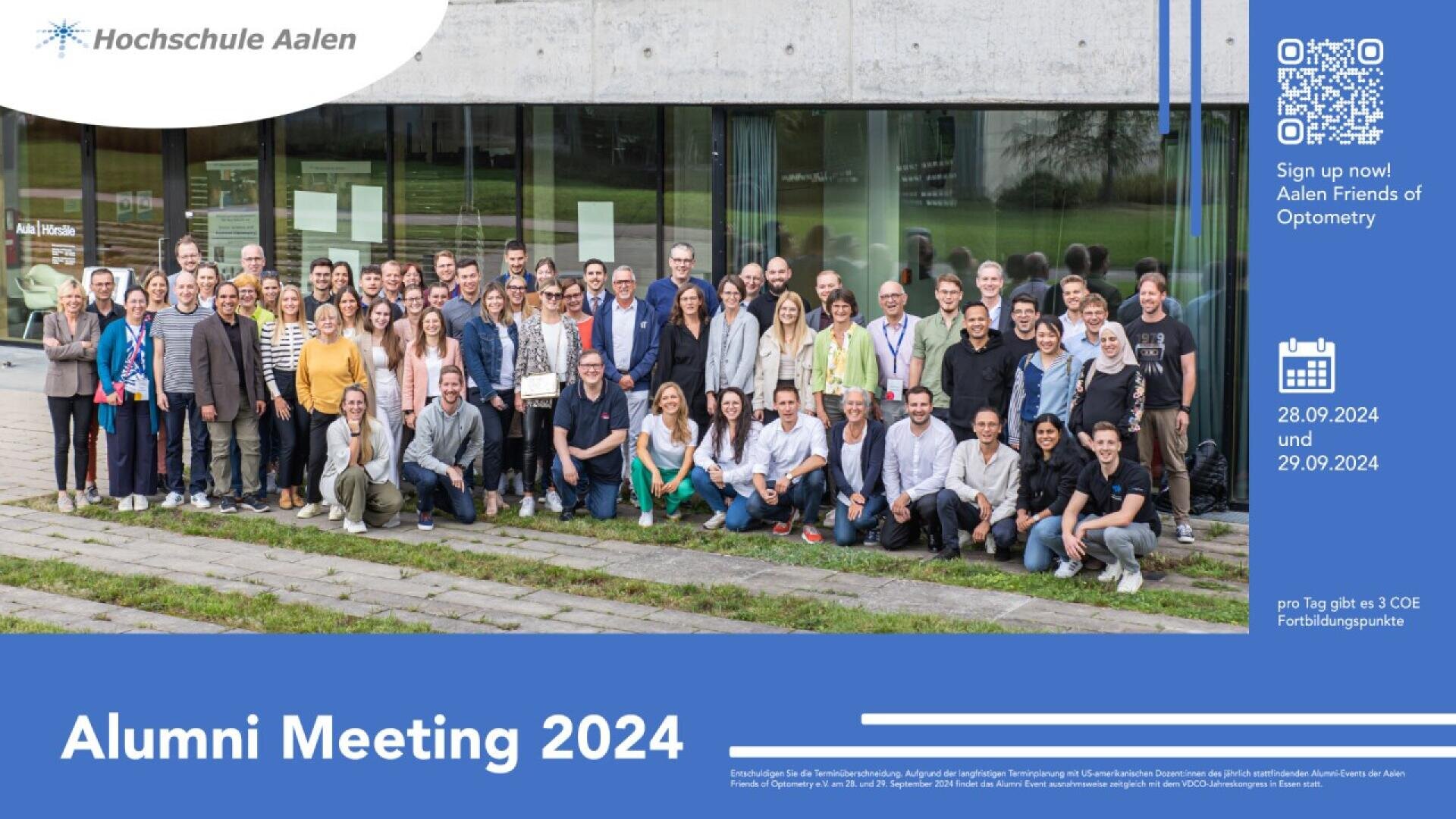 A large group of people pose together outside a modern building with glass walls. On the right, information about the Alumni Meeting 2024 at Hochschule Aalen is displayed with dates, QR code, and event details on a blue background.