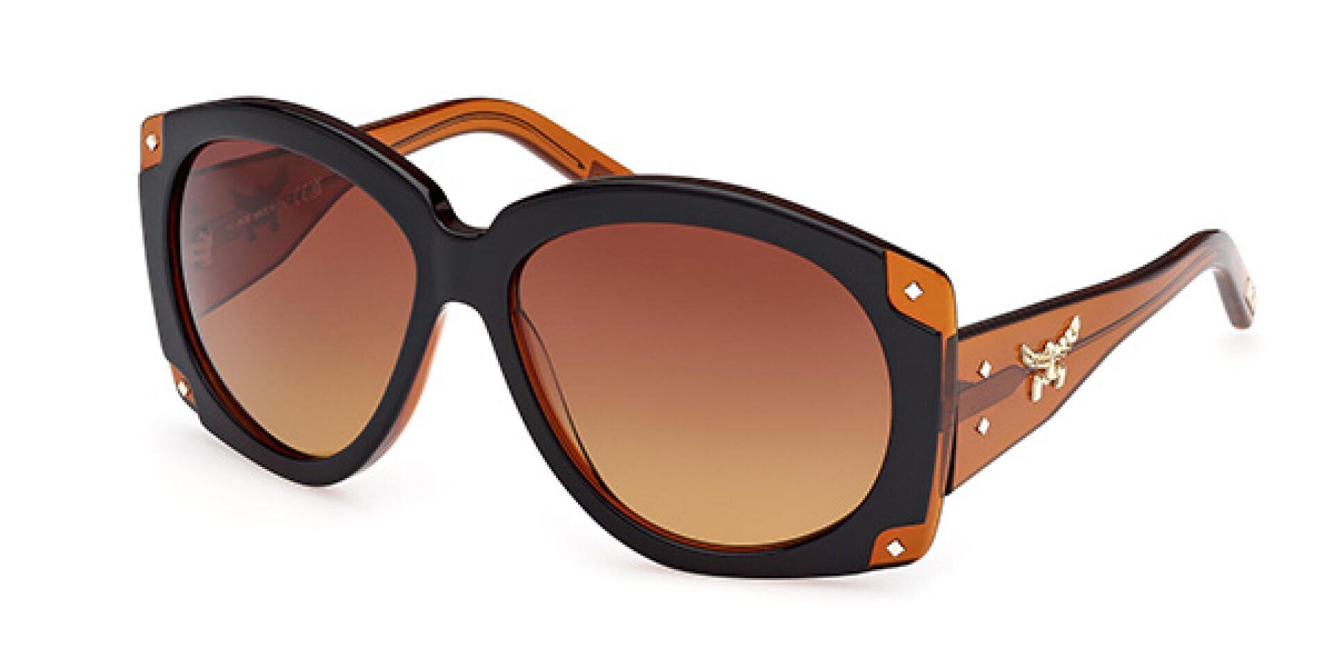 Brown and black oversized sunglasses with gradient brown lenses, gold decorative accents on the corners, and a small golden emblem on the arms near the hinges.
