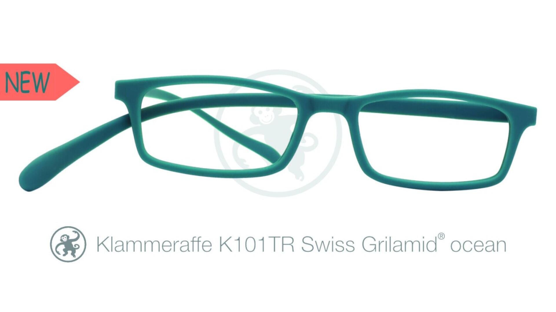 Turquoise rectangular eyeglass frames with a NEW label on the left. Text below reads Klammeraffe K101TR Swiss Grilamid ocean with a monkey logo beside it.
