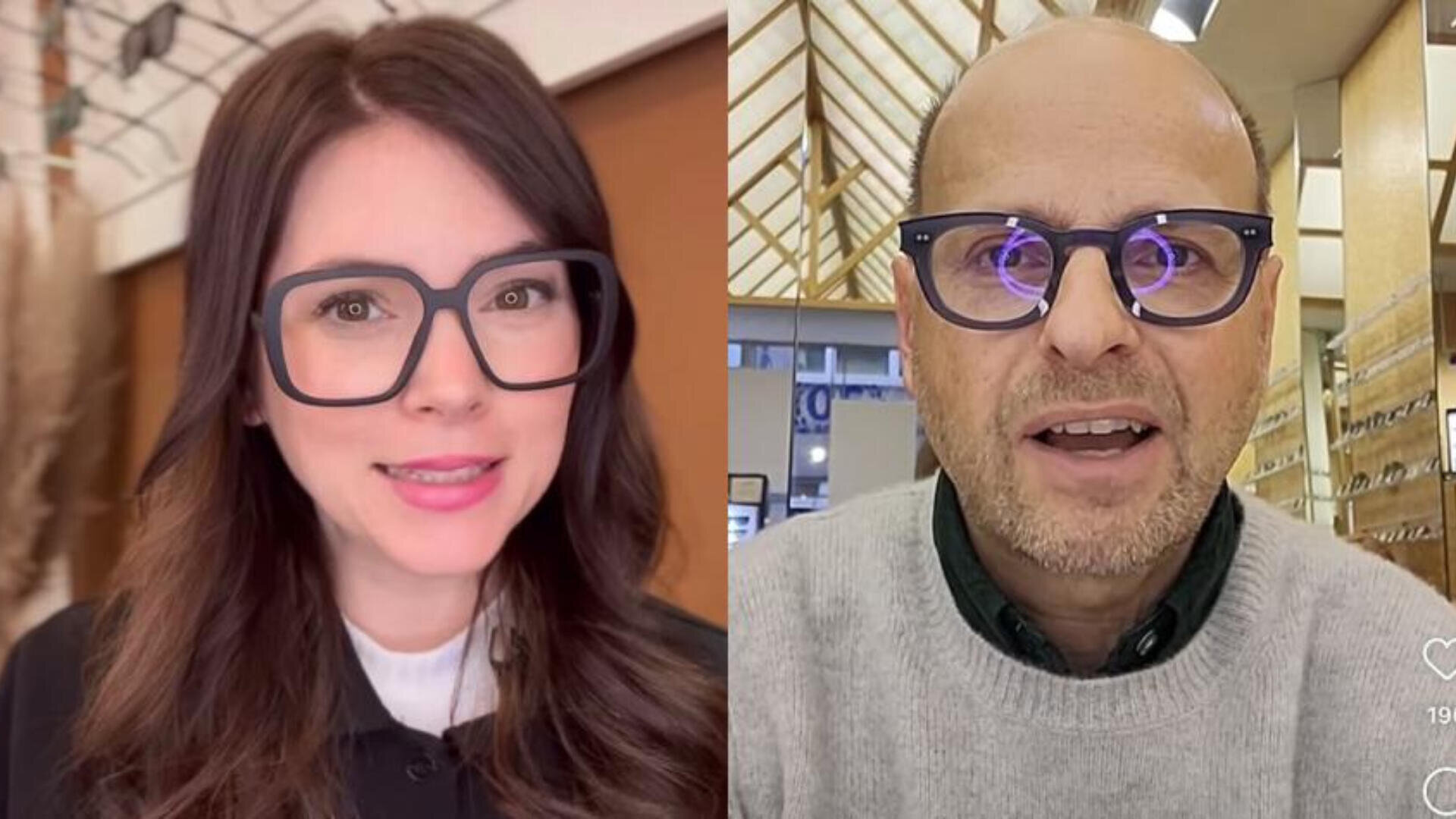 Eine Frau mit langen braunen Haaren und ein Mann mit kurzen Haaren, beide tragen große schwarze Brillen, sind nebeneinander in einem Raum zu sehen. Die Frau lächelt leicht und der Mann scheint zu sprechen.