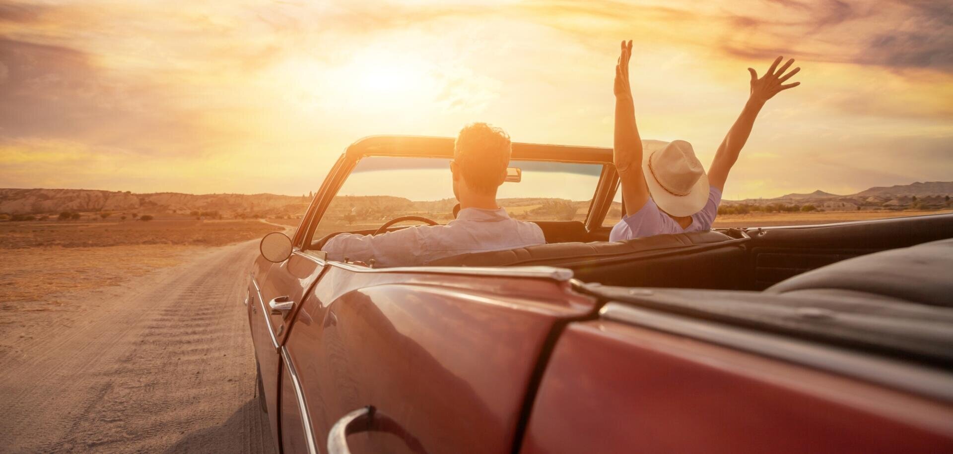 happy people traveling in classic vintage car, couple during honeymoon