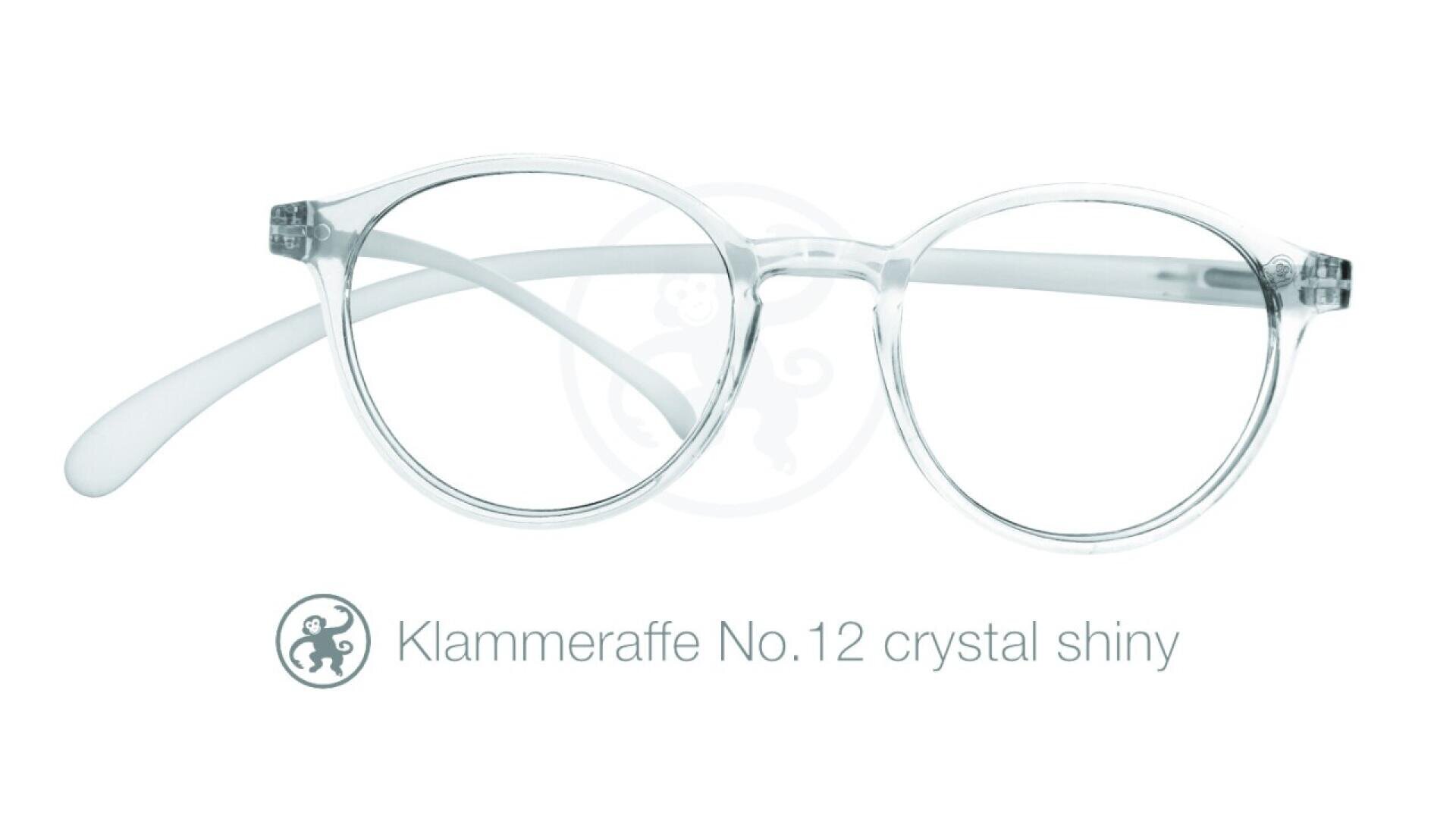 Klare Brille mit rundem Rahmen und glänzendem Kristall-Finish auf weißem Hintergrund. Der Text darunter lautet „Klammeraffe Nr. 12 kristallglänzend“ mit einem kleinen Affen-Logo auf der linken Seite.