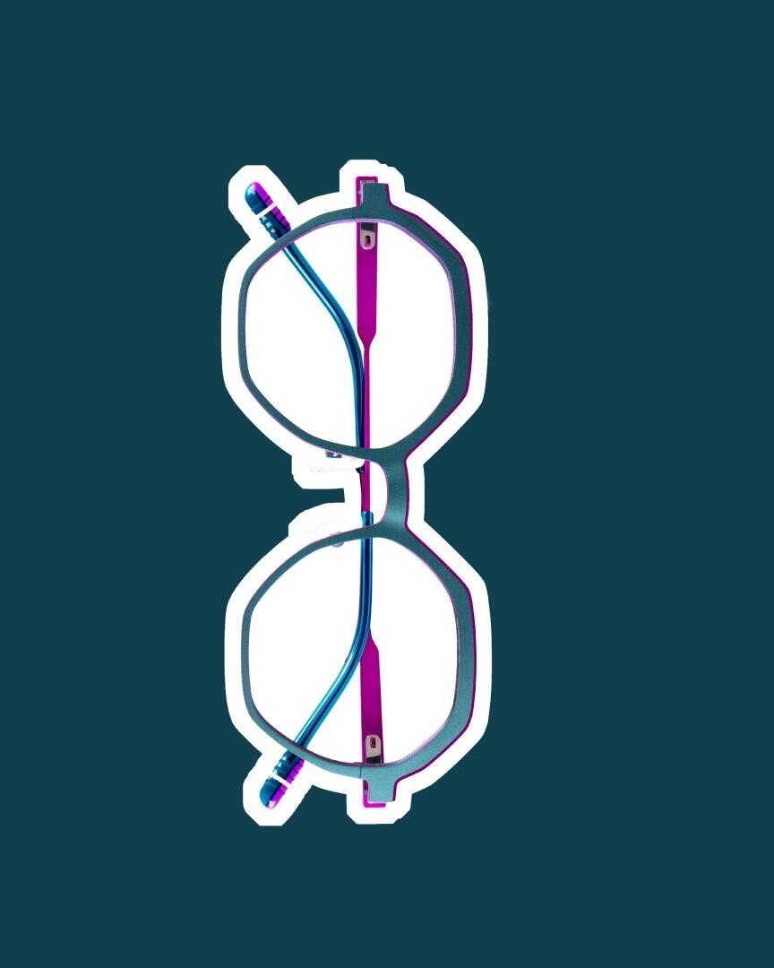 Glasses with blue and purple frames stand vertically on a dark, blue-green background, with a white outline emphasizing their shape.