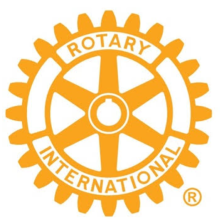 Das orange-weiße Logo von Rotary International zeigt ein Zahnrad mit dem Schriftzug Rotary International in einem kreisförmigen Band in der Mitte.